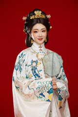 Fototapeta premium Girl wearing Chinese Ming Dynasty Hanfu costume against a red background