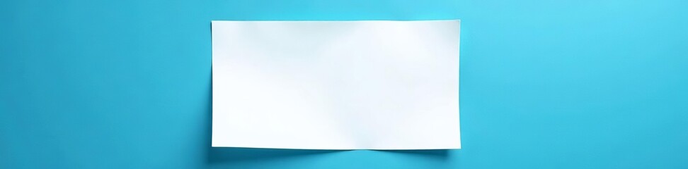 Single blank white piece of paper on blue surface, isolated, simple, clean