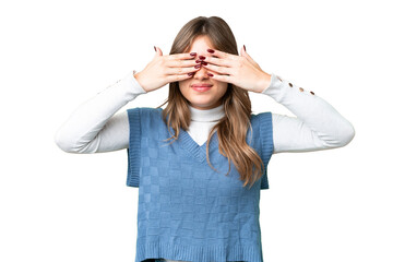 Young girl over isolated chroma key background covering eyes by hands and smiling