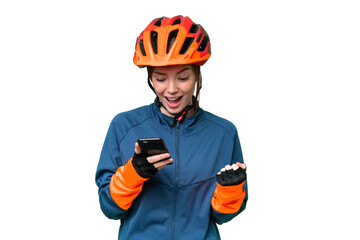 Young cyclist woman over isolated chroma key background surprised and sending a message