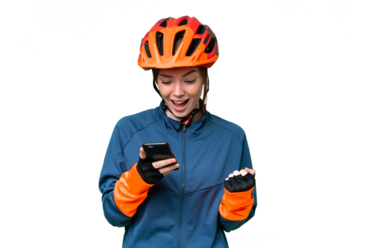 Young cyclist woman over isolated chroma key background surprised and sending a message