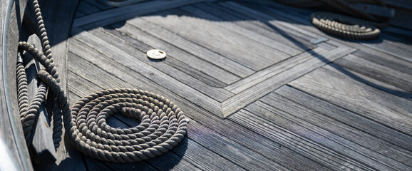 Nautical ropes on a wooden deck. Boat detail