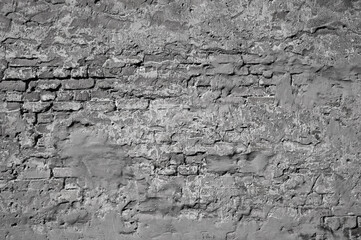 gray background, in the photo an old brick wall and gray plaster