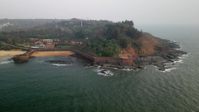 Aerial view of Aguada Fort coastline in Goa, India at sunset