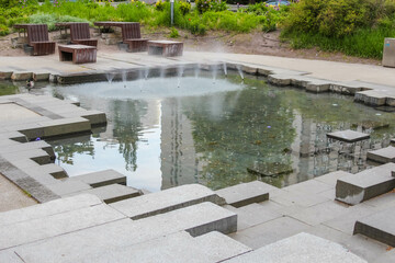 Modern Urban Water Feature with Geometric Stone Elements Creating Minimalist Landscape Design