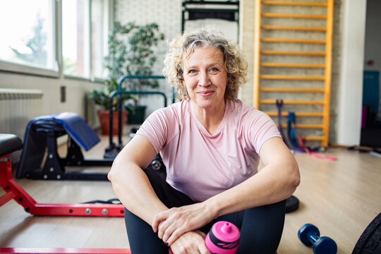 Portrait of a confident senior woman relaxing after gym workout session