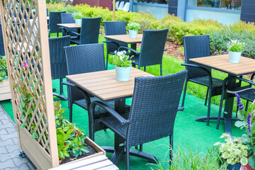 Outdoor Restaurant Terrace with Green Artificial Turf and Modern Black Dining Furniture