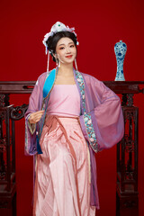 Beautiful woman wearing Chinese Ming Dynasty Hanfu with hairpin and flower ornaments on red...