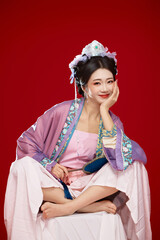 Beautiful woman wearing Chinese Ming Dynasty Hanfu with hairpin and flower ornaments on red...