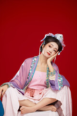 Beautiful woman wearing Chinese Ming Dynasty Hanfu with hairpin and flower ornaments on red...