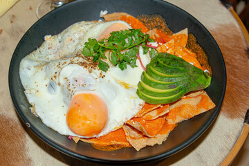Chilaquiles with Fried Egg – Traditional Mexican Breakfast..