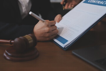Judge gavel with Justice lawyers having team meeting at law firm background. Concepts of Law and...