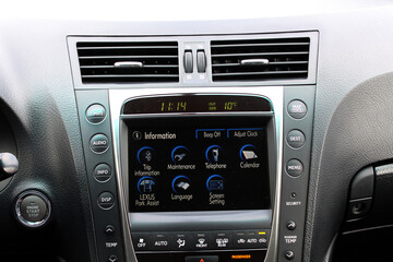 Old car multimedia system screen. Dashboard in a modern classic car. Control Panel of a old business car. Climate control old car. Conditioner in lux sedan.