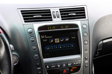 Old car multimedia system screen. Dashboard in a modern classic car. Control Panel of a old business car. Climate control old car. Conditioner in lux sedan.