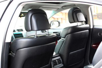 Close-up of the front seat back of a lux car. Front drivers and passenger seat back of matte black...