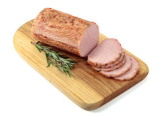 Sliced ham with rosemary on a cutting board.