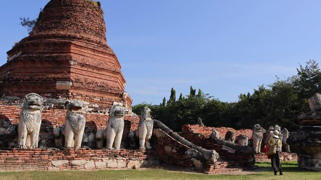 Footage of Woman Climbing onto the Ancient Pagoda Ruins of Wat Thammikarat Buddhist Temple, Ayutthaya Historical Park, Thailand