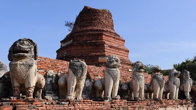 Footage of Bell Shaped Pagoda Called Chedi Ruins Surrounded by 52 Lion Statues of Wat Thammikarat Buddhist Temple, Ayutthaya Historical Park, Thailand