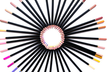 Obraz premium Bright colored pencils forming a perfect circle on a clean white background, top view. A creative and artistic composition with soft focus, symbolizing color and harmony.