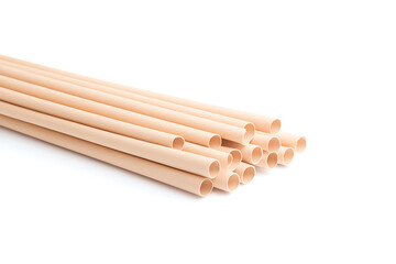 Stack of beige tubes. Group of round pipes laying on white background. Cylindrical objects. Pipeline. Conduit. Beige-colored plastic material.