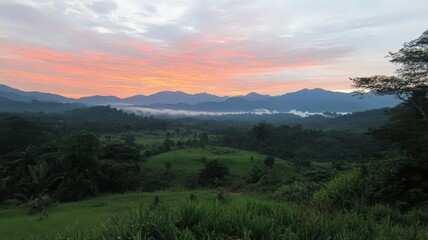 Obraz premium Warm Colored Sky Above Dark Mountains with Mist