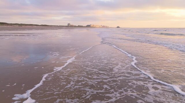 Sunset Coastal Glide with Distant Pier and Breaking Waves | FlyLens 4K
