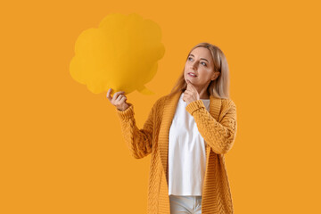 Thoughtful mature woman with blank speech bubble on yellow background