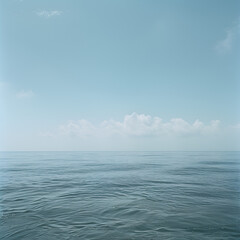 Fototapeta premium Serene Ocean Scene under a Blue Sky with Clouds