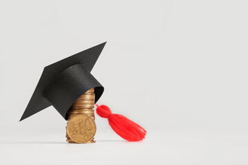 Graduation hat with money on table against white background. Tuition fees concept