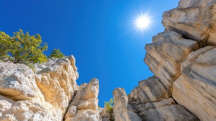 Striated rock formations under a clear blue sky with bright sunlight