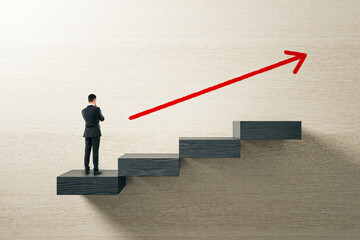 Businessman standing on black staircase steps with red upward arrow symbolizing career growth and...
