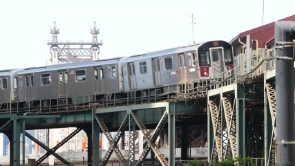 New York elevated subway, metropolitan bridge, metro track above street. Railway transport, vintage Queensboro station railroad line. Queens public train transportation. Long Island city United States - Powered by Adobe