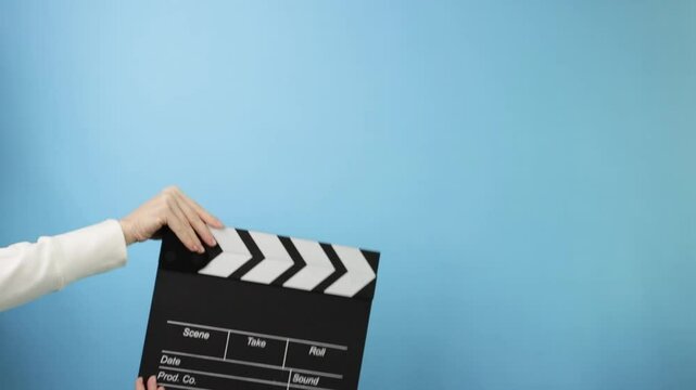 Hands holding a clapboard, symbolizing cinema, Hollywood, and the film industry