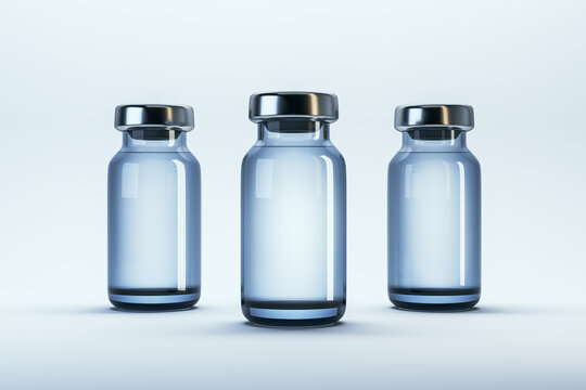 Three blank medical glass vials with metallic caps standing upright on clean light background for branding or packaging mockup template design concept. 3D Rendering