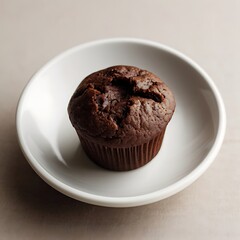 Delicious chocolate chip muffin, a sweet baked pastry, and a plain chocolate muffin sit on an isolated white plate, a tasty treat