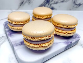 Fototapeta premium French Macarons in Pastel Colors, Arranged on a Marble Tray with a Minimalist Background