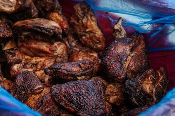 A close-up of freshly grilled meat pieces stacked together, featuring crispy, charred edges and tender, juicy textures ideal for BBQ and culinary visuals.