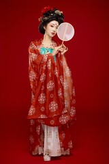 Tang Dynasty style female ancient costume makeup modeling on red background