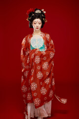 Fototapeta premium Tang Dynasty style female ancient costume makeup modeling on red background