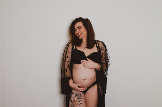 Femme enceinte en sous v&ecirc;tement noir sur fond blanc