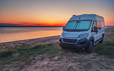 panoramic sea view and white camper in sunset time with copy space in sky