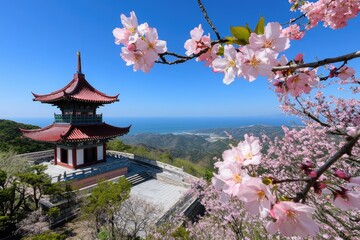 Fototapeta premium Scenic pagoda amidst cherry blossoms overlooking coastline landscape
