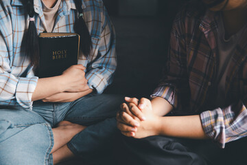 Close up group christians hands pray to God with spiritual faith on holy bible in catholic church. religion worship prayer ask god bless grace jesus believe. Christianity religion prayer holy worship