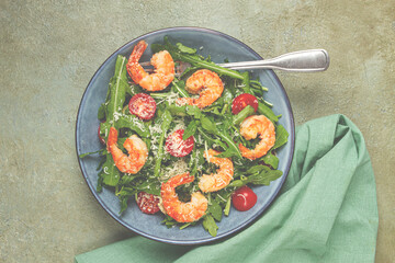 Shrimp salad with arugula and cherry tomatoes, with parmesan cheese, healthy food,