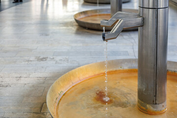 Modern public water fountain with flowing water in urban setting
