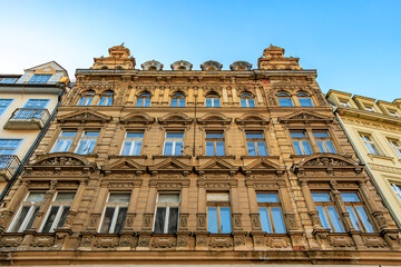 Historic european building facade with ornate architecture and clear blue sky