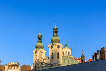 Historic baroque architecture of church with twin towers against clear blue sky