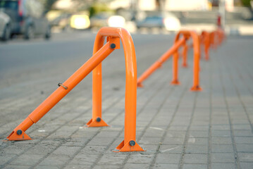 Row of folding car parking barrier closeup, reserved space and vehicle access control in city zone. Parking space secured by metal barrier, restrict vehicle entry, reserve spot for authorized use only