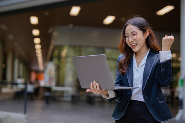 Happy and excited young Asian woman after discussing successful project at work and working concept at office.