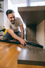 Man Vacuuming Table